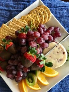 plate with fruits, cheese and crackers 