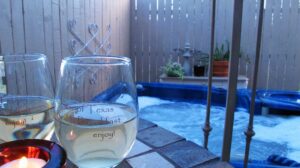 wine glasses on table next to hot tub 
