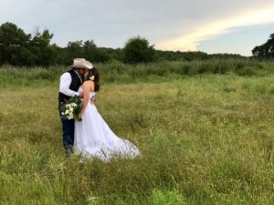eloping couple kissing in a field in Texas