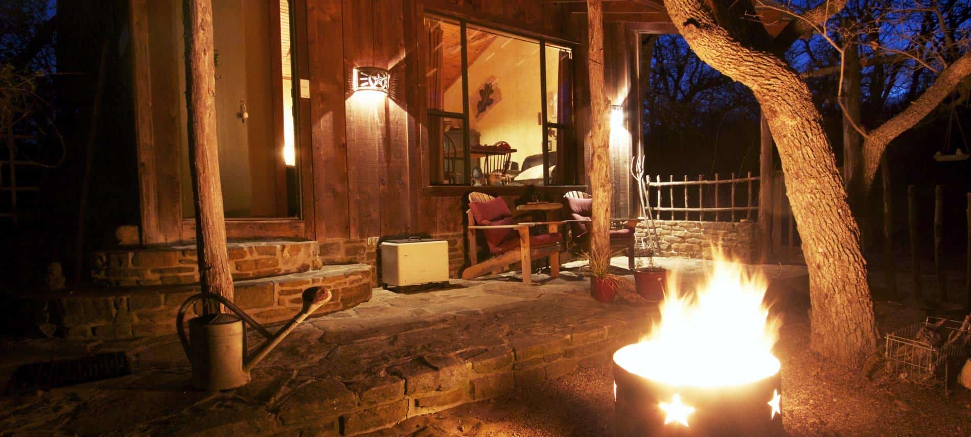 Cozy campfire and night outside one of the rustic cabins